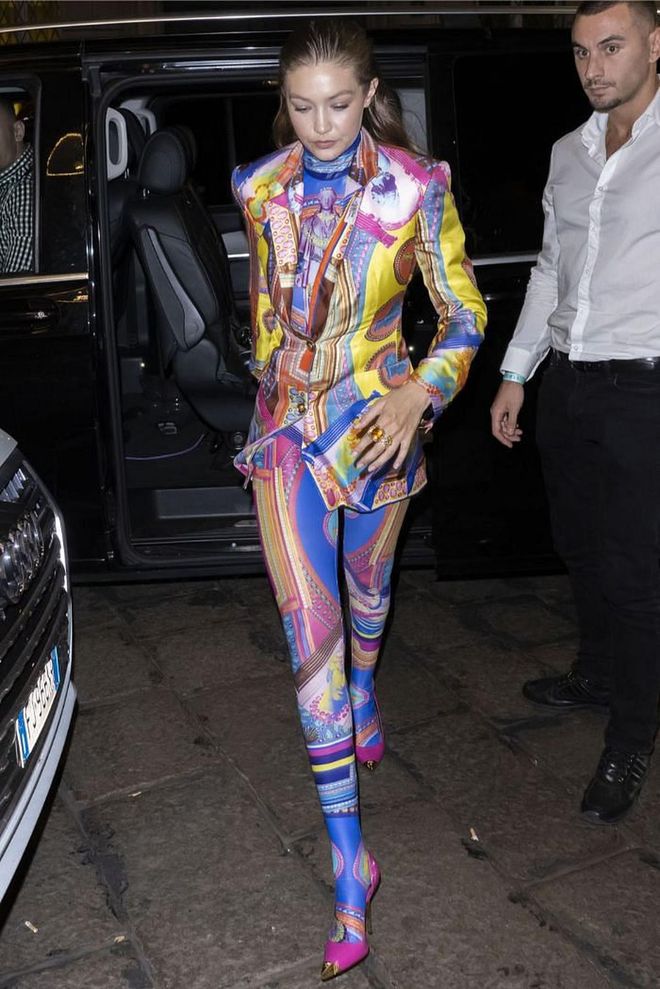 Gigi Hadid opted for a multi-patterned Versace look and fuchsia courts.

Photo: Getty