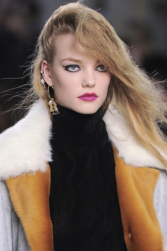 Makeup artist Hannah Murray described the heavy winged liner and magenta lipstick on the models as what "a club kid who's trying to recreate the 1960s" would wear. But combined with a deep side flip, they looked more like late '80s teens who just walked off a John Hughes set—and we love everything about that.