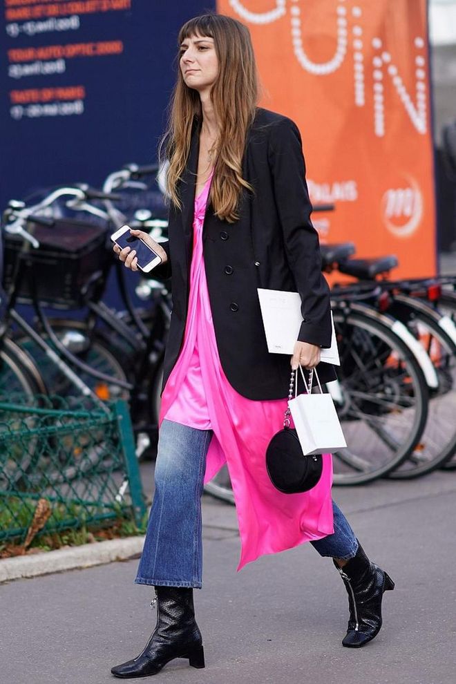 Styling frocks over trousers is all about maximalism so don't try and make it work with clean lines and neutral colours – go big. Play around with longline blazers, bright hues, ankle-length denim and an asymmetric hem. Photo: Getty