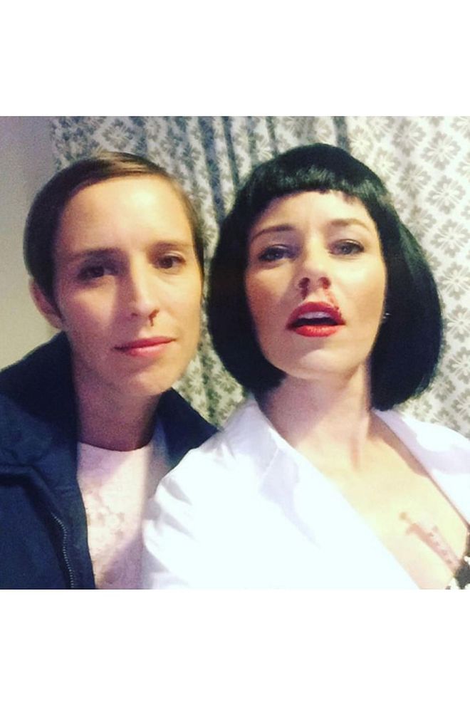 The actress dressed as Mia Wallace and posed with a party-goer dressed as Stranger Things' Eleven.