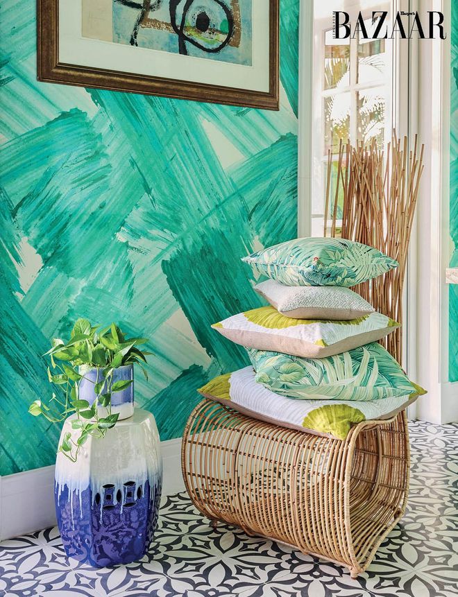 A pile of botanical-print cushions of her design echoes the abstract motif of the wallpaper that runs throughout the rooms on the first floor. Photo: Lawrence Teo