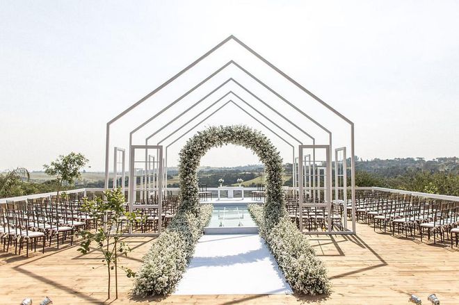 Last year's weddings were all about color, iridescence, lucite and more–but we’re anticipating a stronger shift to minimal structures and open environments come Fall. Be it al fresco, in a field, or in a gallery, sleek structures are a new way to think about tents, ceremony markers, and the ways to frame your festivities. White and all 50 shades of grey drive this trend, but pops of deep, rich monochromatic color can add personality to these industrial structures.

Photo: Getty