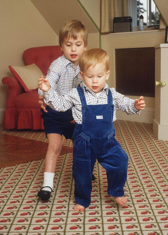Prince William helps one-year-old Prince Harry take his first steps in this sweet snap, which was taken at Kensington Palace.
Photo: Getty