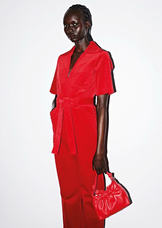 A belted corduroy jumpsuit with a matching leather pouch bag in festive red.

Photo: Courtesy of & Other Stories