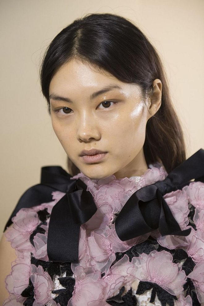 The skin at Giambattista Valli had a mirror-like sheen—as if it had been highlighted and moisturized using Vaseline.