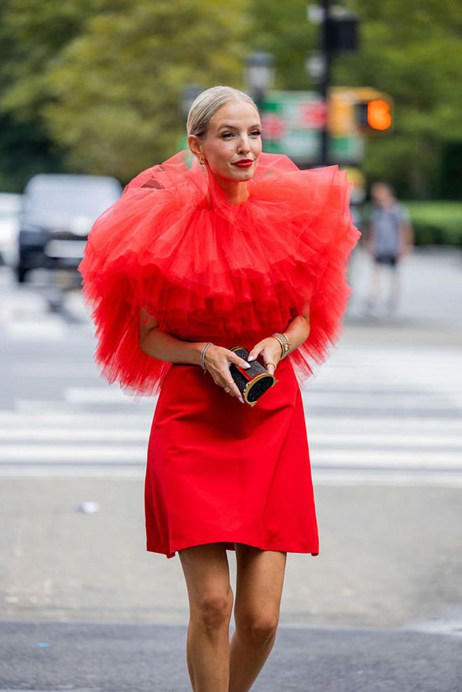 NEW YORK, NEW YORK - SEPTEMBER 13: Leonie Hanne wearing a bright orange dress, puffed at the top. (Photo by Christian Vierig/Getty Images)