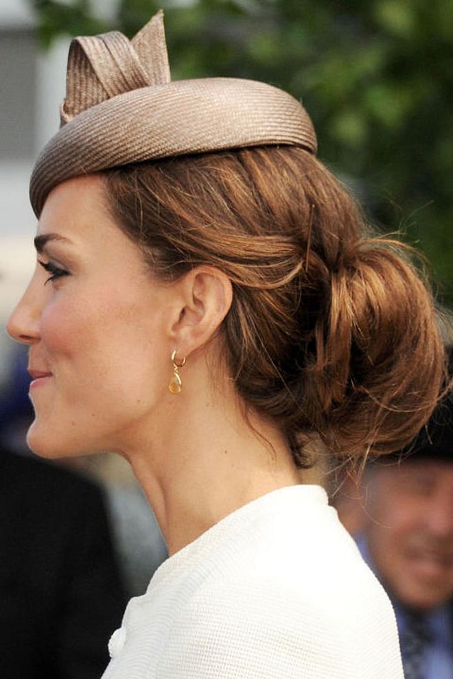 An unfussy updo fit for a princess is never complete without a fantastic fascinator. Photo: Getty