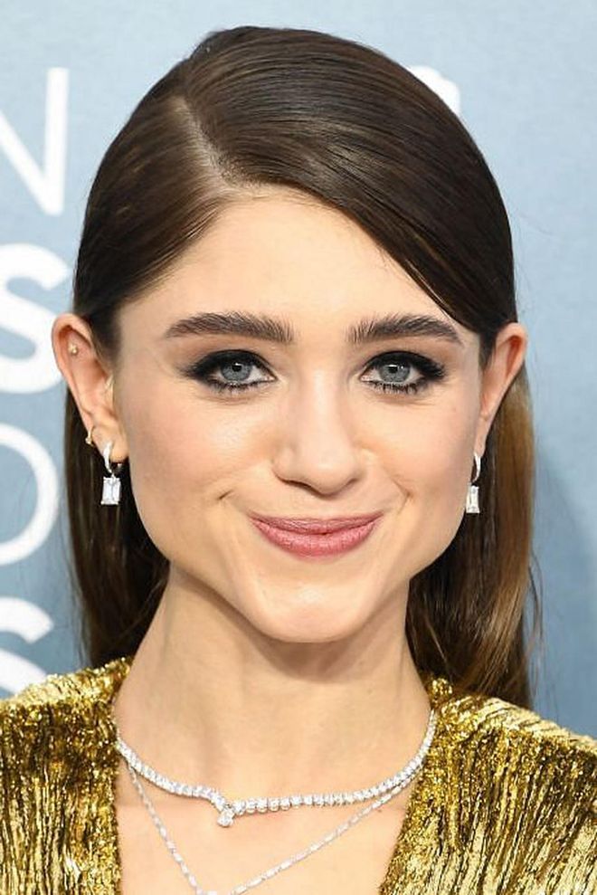 Natalia Dyer went for a traditional smoky eye, with brushed-up brows and a polished complexion. Her hair, styled sleek and tucked behind both ears, was impossibly shiny.

Photo: Steve Granitz / Getty