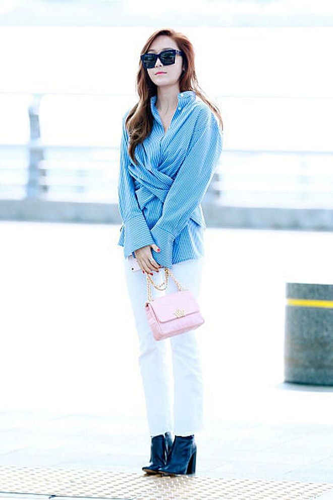 Posing for the paparazzi outside at Incheon Airport, Jung shocks us again with a wrapped striped shirt with white jeans and a pink purse. Honestly, this is a look that we can pull off for work. 