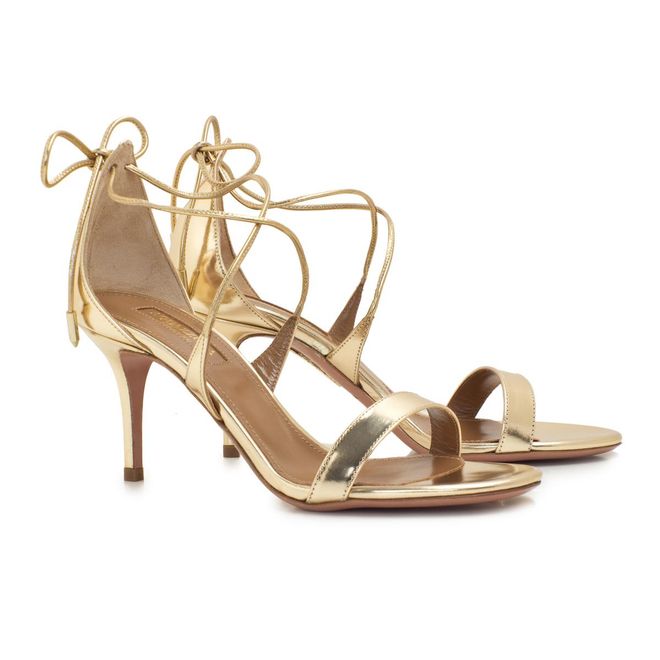 Modern yet elegant metallic gold sandals with a flattering lace tie ankle design, this Aquazzura Linda Light Gold Sandals adds a touch of sparkle to any look.