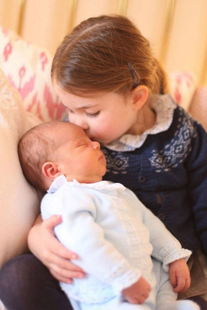 In a moment that made hearts melt around the world, Kensington Palace released new photos of Prince Louis taken by the Duchess of Cambridge. One photo was particularly adorable, showing new big sister Princess Charlotte giving him a tender kiss on the forehead.