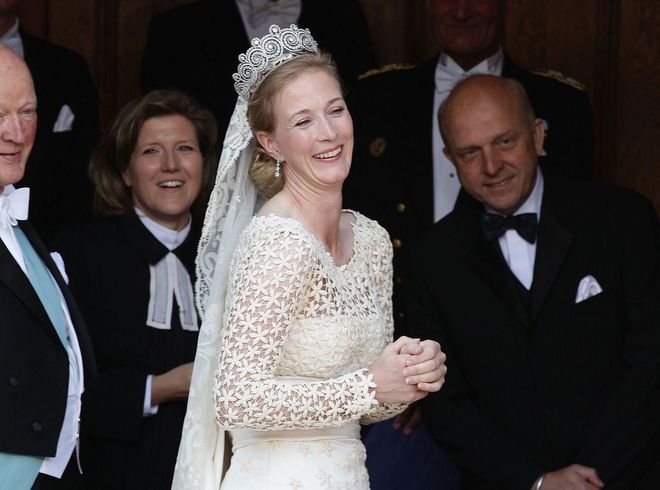 Princess Nathalie zu Sayn-Wittgenstein-Berleburg of Denmark forgot her bouquet and had to wait almost ten minutes for it to arrive before she walked down the aisle. This is a photo of her waiting—fortunately, she doesn't look too stressed.