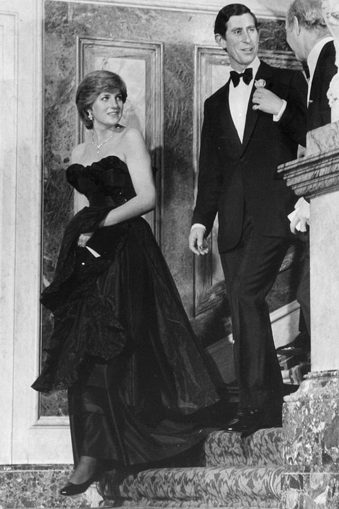 Diana — who was only 19 years old at the time — wore a strapless black taffeta gown by Emanuel to her first public outing with Prince Charles. Because it was strapless, Diana was photographed with her décolletage spilling out of the top when she was getting out of her car, and the public went nuts for Daring Di. "We hadn't considered the fact that when Diana bent over — as she would have to do when getting out of the car — she would show quite a lot of cleavage," wrote designer Elizabeth Emanual. "We just thought she looked fabulous."