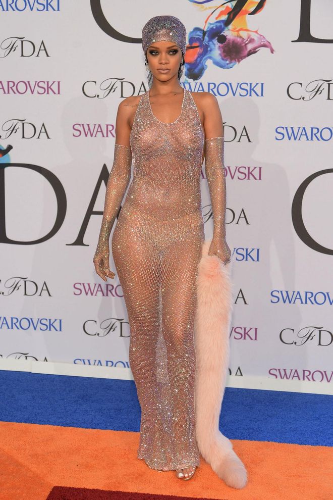 Rihanna always surprises with her original approach to style, but the sheer bejewelled dress she wore to the 2014 CFDAs shocked more than most. Part Josephine Baker, part sphinx, the pop star teamed the look with a glittering turban, a fur stole and a nude thong to hide her modesty. Rumour has it that she chose the dress to show ex-boyfriend Drake what he was missing.

