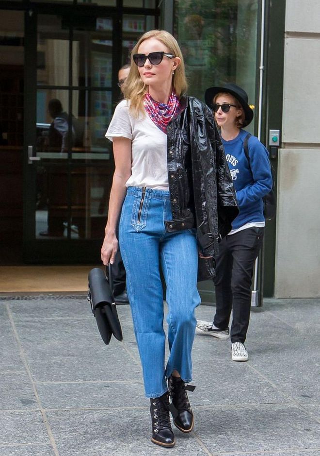 A simple pairing of jeans and a tee is elevated by a shimmering Paco Rabanne neck scarf tied in the manner of cowboys everywhere.

Photo: Tal Rubin / Getty