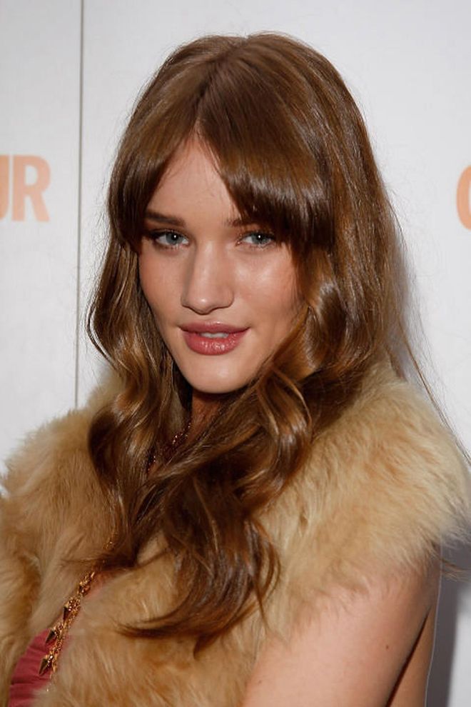 The style: Rosie Huntington-Whiteley stepped onto the scene with glossy, wavy locks and a heavy, grown-out fringe. Photo: Getty