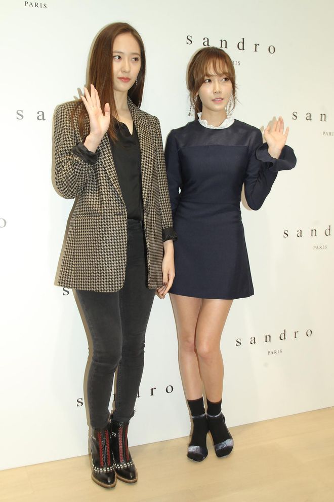 Jessica and her sister, Krystal, attend a Sandro opening in Hong Kong. In contrast to Krystal's menswear-inspired outfit, Jessica goes for a Wednesday Addams-inspired navy blue dress with socks and sandals shoes. This won't be the last time we'll see her wear socks with sandals. 