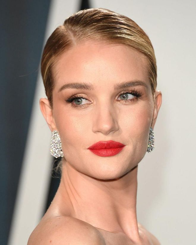 Huntington-Whiteley played up one of her most famous features with a bold red lipstick. YSL Rouge Pur Couture The Slim in Strange Orange, a photogenic orange-toned red, works well with warm undertones.