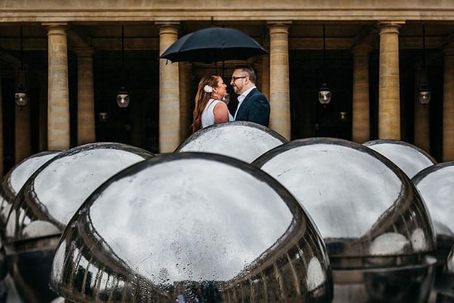 Set in the 1st arrondissement of Paris, the Palais-Royal with its striking columns once served as childhood home of Louis XIV. In this special moment, it also made a beautiful backdrop amid the rain for a couple to celebrate their love.

Via Sean and Molly Photography

