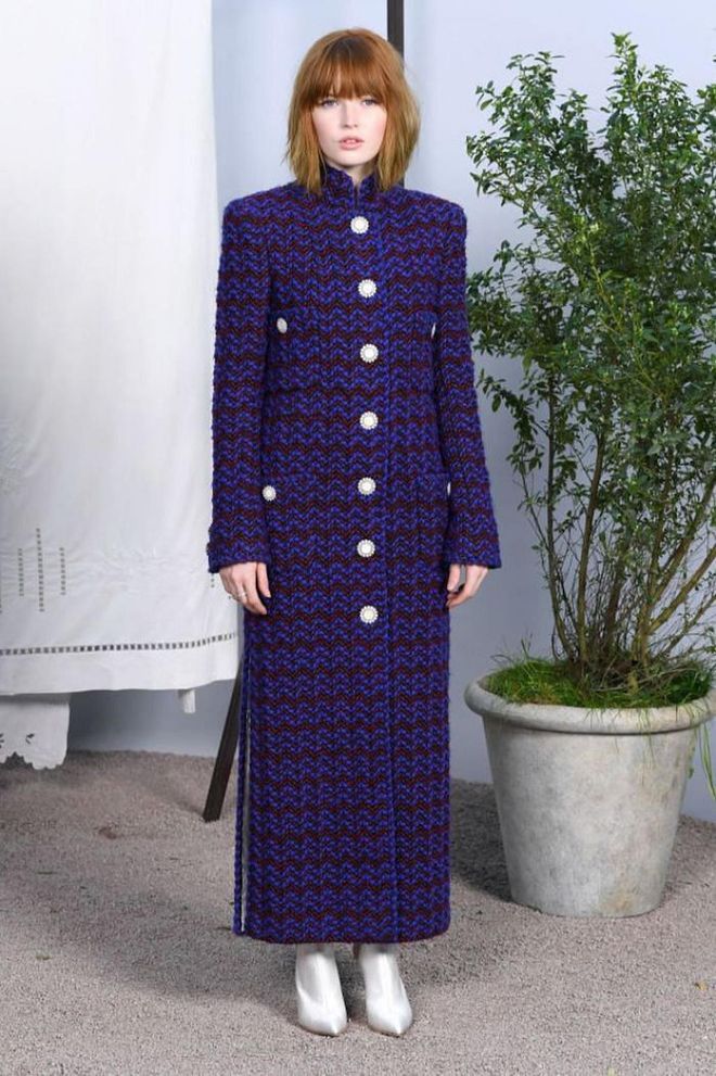 Ellie Bamber attended the couture show in a floor-length coat and pointed white boots.