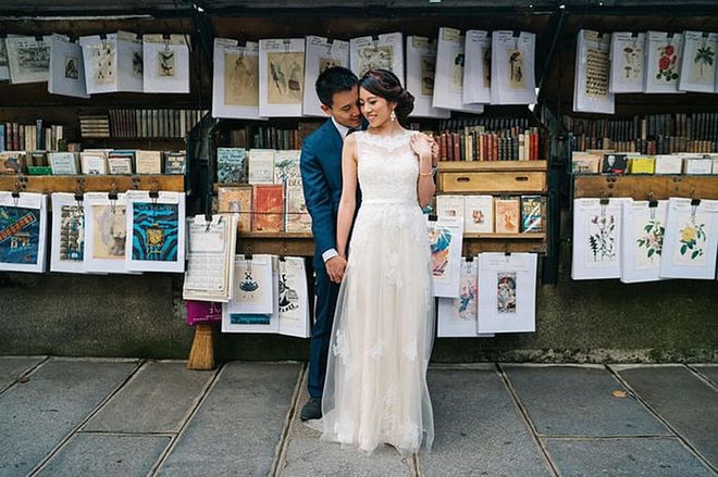 On any given day, the famous newsstand Quai de Montebello in front of the Notre Dame is brimming with old Parisian books, artwork and newspapers. For this couple's wedding day, it also makes the perfect spot for a retro romantic photo.

Via Sasha Reiko Photography
