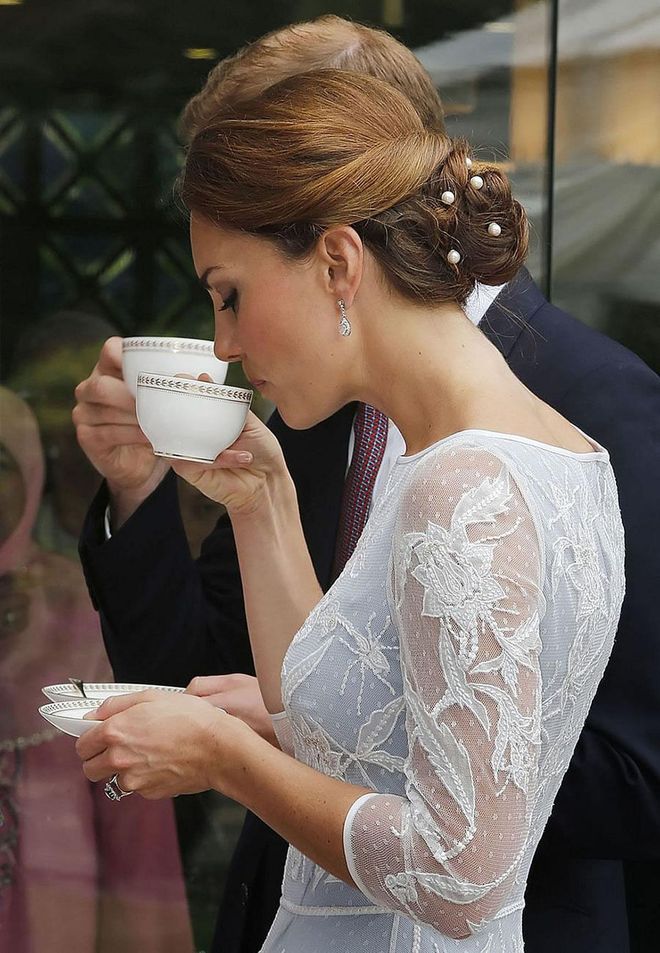 Royals are expected to take part in many afternoon teas (which is not referred to as "high tea," which despite being dubbed 'high' is actually a more casual service.) Tea cups are held in a specific manner, pinching the top of the handle with your thumb and index finger, and placing your middle finger to support the bottom of the handle. The handle of the cup should always be kept at 3 o’clock, and royal women are advised to try and sip from the same spot to avoid getting lipstick stains around the rim.
Photo: Getty