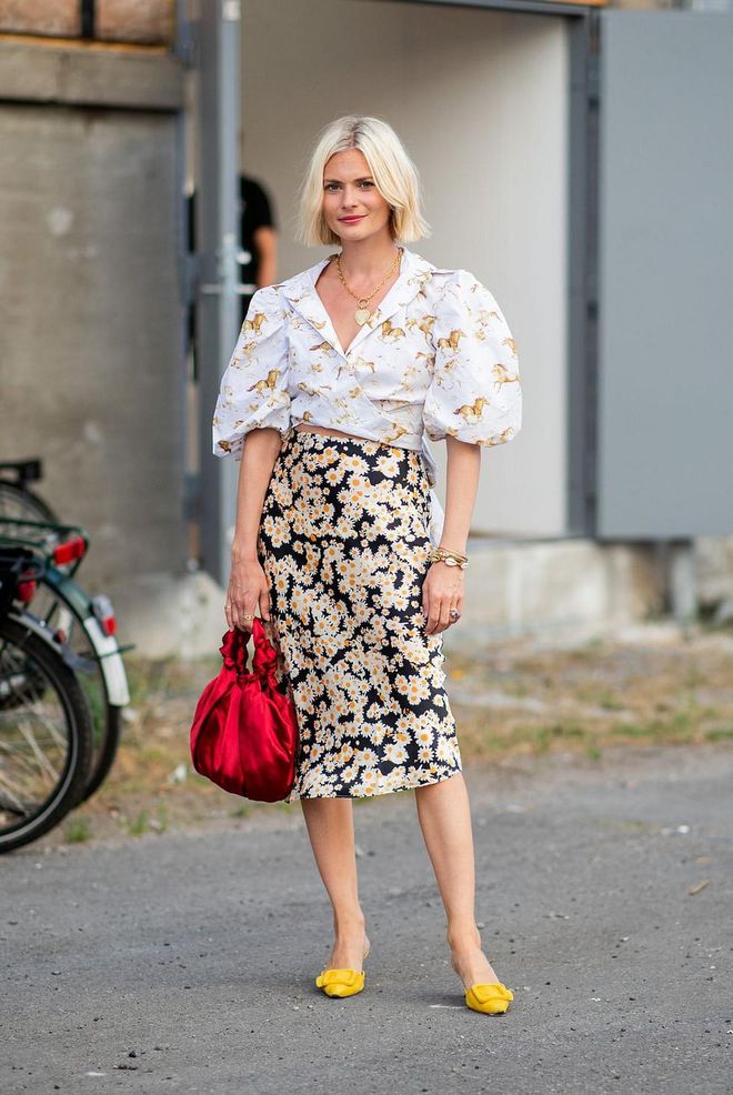 A puff-sleeve top and daisy-print skirt is a match made in going-out heaven.

Photo: Christian Vierig / Getty