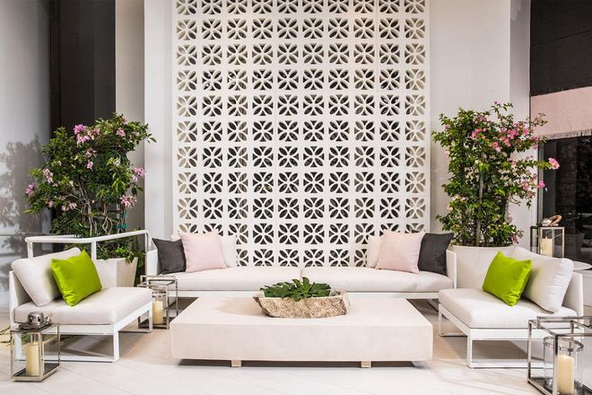 Paired with eye-catching fashion house Pucci, Daniela Saliba's space is nicknamed "The Outdoor Comfort," for its airy green-pink-white color combination. Sleek chaise lounge chairs line the space, and a stylish laser-cut wooden screen is reminiscent of our favorite Pucci prints.