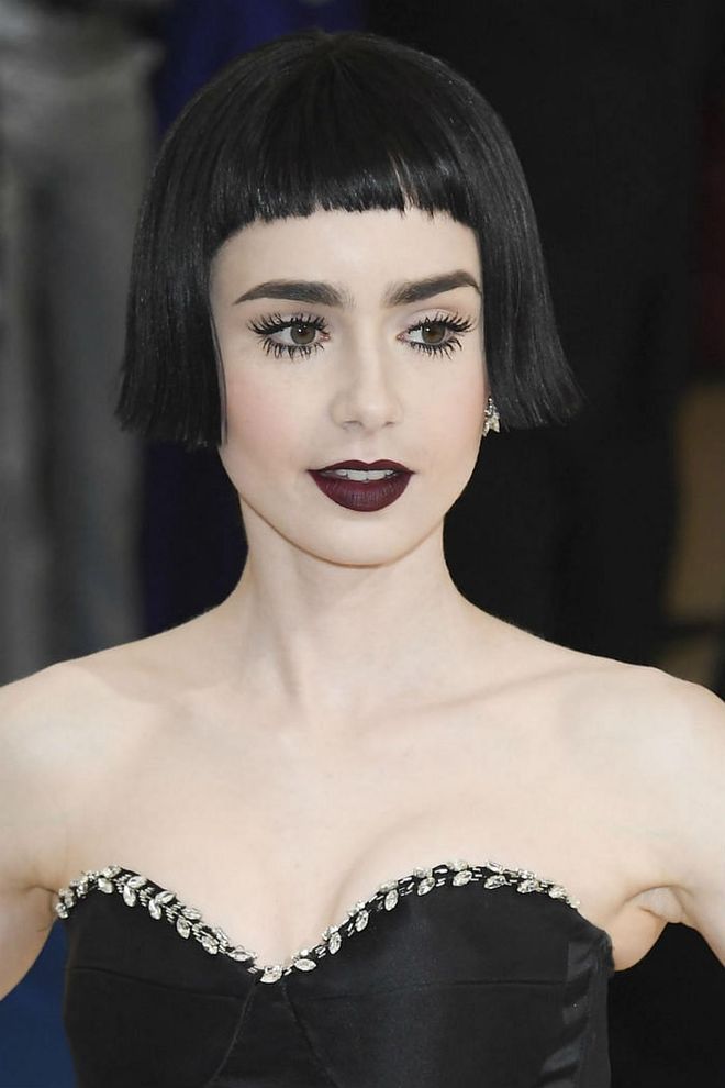 This refreshing jet-black bob with blunt bangs on Lily Collins brings about a whiff of 1920's flapper girl flair with a futuristic twist (Photo: Getty)