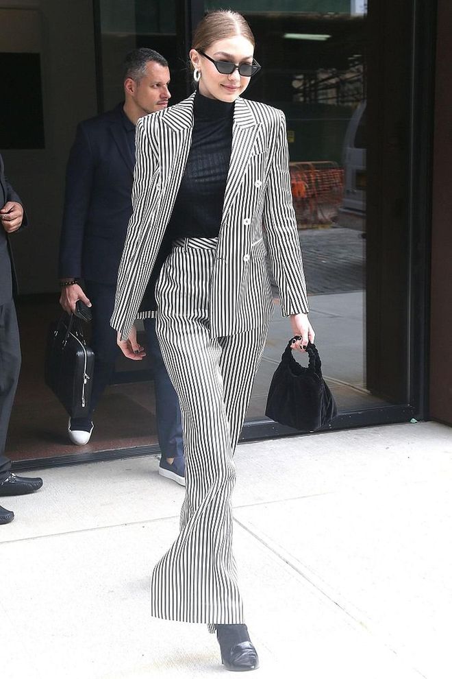 In a black and white striped pantsuit