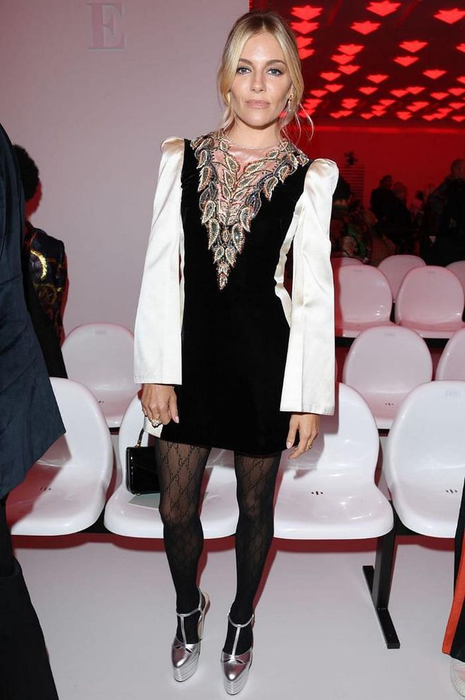 Sienna Miller wore a mini dress with flared sleeves and platforms to sit front row at Gucci.

Photo: Getty Images