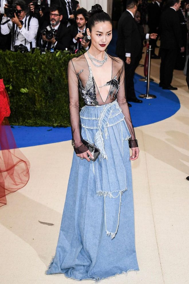 Liu Wen combines sexy, casual and glam with this gorgeous gown. A see-through top that's strategically sequinned with bird-patterns atop a full skirt in an unexpected casual material. She is serving all the looks tonight. Photo: Getty