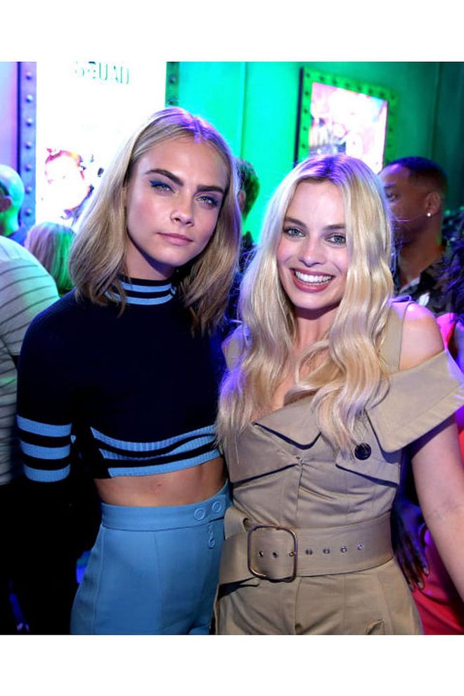 Cara Delevingne in a two-piece Versace set and Margot Robbie at San Diego Comic-Con 2016. Photo: Getty